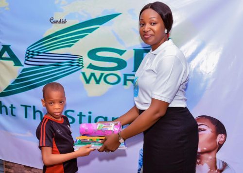 Little boy with vitiligo accepting school supplies for Back to School