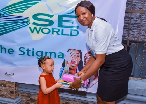 Little girl with albinism accepting school supplies for Back to School 